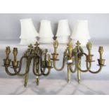 Four Regency style two branch wall lights in a gilt finish and eight shades.