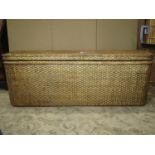 A large contemporary wicker box ottoman of rectangular form with rounded corners, hinged lid with