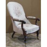 A Victorian spoon back drawing room chair with rosewood show wood frame, open scrolled arms,