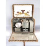 A vintage travelling picnic set with kettle and burner, sandwich box, etc, in its original wicker