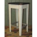 A vintage painted aluminium industrial stool with rectangular rexine/oil cloth upholstered seat