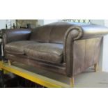 Laura Ashley Glenister brown leather upholstered sofa with swept and rolled arms, loose scroll