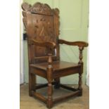 An old English oak Wainscot chair of usual form with carved and panelled framework