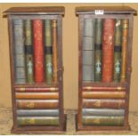 Pair of small novelty wooden cabinets, each enclosed by a single door, with mock book spines