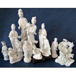 Twelve Chinese blanc de chine porcelain figures including Guanyin, mythical beast standing on a