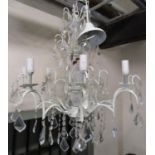 A contemporary eight branch cream painted light metal chandelier with moulded glass stem and faceted