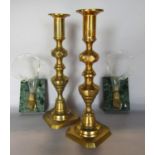 A pair of late 19th century cornucopia glass spill vases with gilded clenched fist mounts, raised on