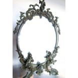 An ornate Rococo style bronze finished metal dressing table mirror adorned with scrolls, flowers and