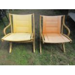 A pair of bound cane folding garden/conservatory chairs with canvas seats and backs in varying