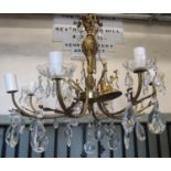 A cast gilt metal eight branch chandelier with acanthus detail and faceted tear drops 60 cm drop