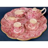 A Copeland Spode tea service with all over floral pink decoration and gilt highlights comprising