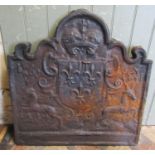 A heavy cast iron fireback with stag, shield and crown detail, 68cm wide x 69cm high (af cracked)