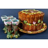 A large majolica cheese dome with wood effect decoration and floral garlands (af, handle to top of