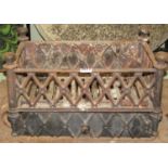 A small Regency Gothic style cast iron fire basket of rectangular form with repeating open lattice