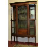 An inlaid Edwardian shallow breakfront display cabinet with banded detail enclosed by three glazed