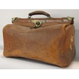 A vintage leather Gladstone bag with decent stitching and a large vintage Pukka suitcase.