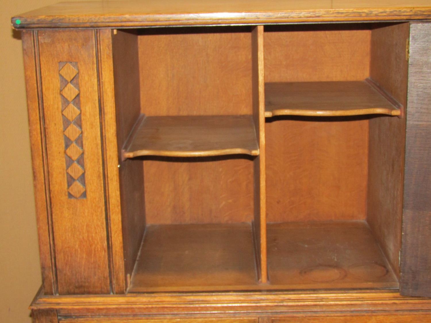 An early 20th century oak freestanding side cupboard enclosed by a central panelled door, with - Image 2 of 5