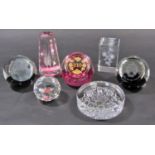 A mixed collection of glass paperweights, ornaments in various shapes and styles