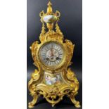 19th century French gilt brass mantle clock in a Rococo style with painted porcelain dial and