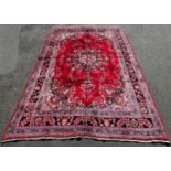 A North East Persian Meshed Carpet in good condition, with a central floral medallion on a