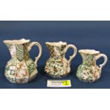 A collection of Mason's Applique table ware comprising a small mantle clock, graduated jugs, vase,
