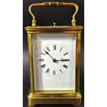 A late 19th century French carriage clock with enamelled dial and eight day striking movement,