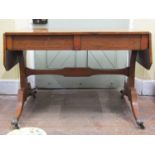 A Regency rosewood sofa table of usual form, with cross banded borders, raised on an open base