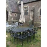 A mat painted cast alloy D end garden terrace table with decorative pierced top, together with a set