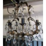 A contemporary light metal chandelier with five candle bulb fittings scrolling leaf detail,