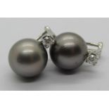 Pair of Tahitian pearl earrings with 18ct white gold clip fastenings, each set with a diamond 0.20ct