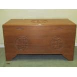 A Chinese hardwood coffer with carved symbols, 91 cm in length, The three symbols the three