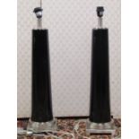 A pair of contemporary table lamps, the polished chrome bases supporting a cylindrical tapering