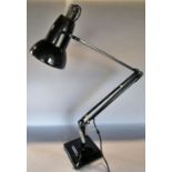 A mid 20th century black Anglepoise lamp on a stepped base, stamped Made in England by Herbert Terry