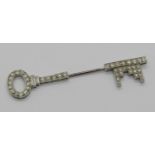 Art Deco style white metal diamond jabot pin in the form of a key, set with round and baguette cut