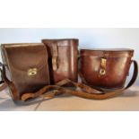 Three pairs of vintage binoculars in their original leather cases.