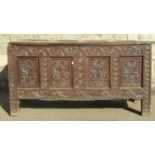 An 18th century oak coffer, the front elevation enclosed by four panels with repeating floral