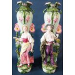 A substantial pair of art nouveau style majolica vases with floral vine decoration and large