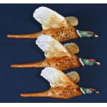 A trio of three graduated Beswick flying pheasant wall plaques, cranberry ware sugar basin, a