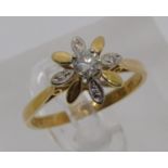 18ct flower head diamond ring, centre stone 0.20ct approx, size L/M, 2.3g