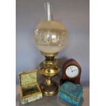 A 19th century brass oil lamp, a mahogany cased mantel clock and a blue and a grey marble