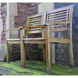 A pair of weathered contemporary hardwood garden open armchairs with slatted seats and backs (af)