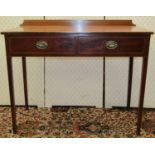 A late Georgian mahogany side table fitted with two frieze drawers raised on square taper legs