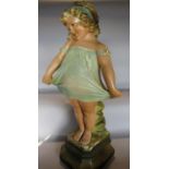 An early 20th century” Pear’s Soap” like plaster statue of a little girl in a twee pose. 60cm tall