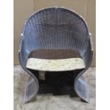 A Pieff "Venus" wicker chair with swept frame and tubular chrome fittings