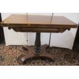 A Regency rosewood foldover top card table, raised on turned column and platform base