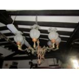 Cast gilt metal eight branch chandelier with scrolling acanthus and female mask detail, bulb
