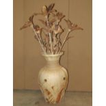 A contemporary overlaid pottery vase with applied detail containing artificial flowers, the vase