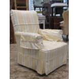 An Edwardian drawing room chair with rolled arms, simply upholstered in white calico with later