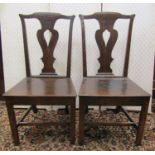 A pair of Georgian oak cottage chairs with pierced vase shaped splats and solid seats with square