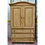 A waxed hanging cupboard, the lower section enclosed by three frieze drawers, the upper section by